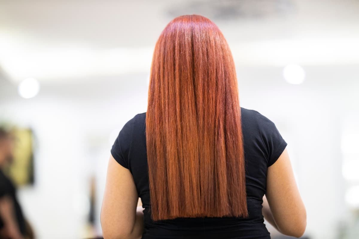 Woman receiving a hair mask treatment at a salon sink
