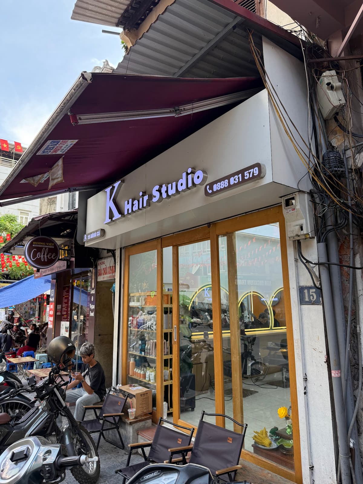 Exterior view of a boutique hair studio in an old Hanoi street